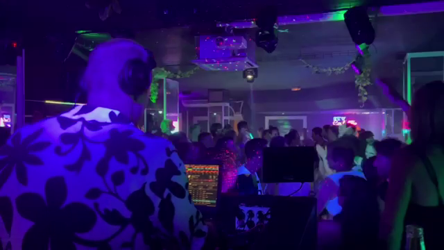 gnarbear DJing in Mallorca on stage in front of a dancing crowd